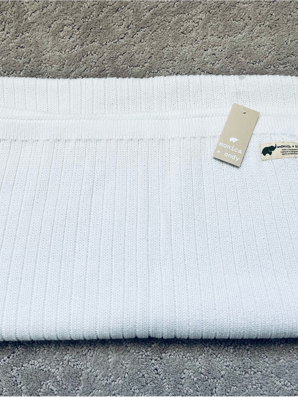 Baby organic cotton blanket  featuring a subtle ribbed or cable-knit texture.